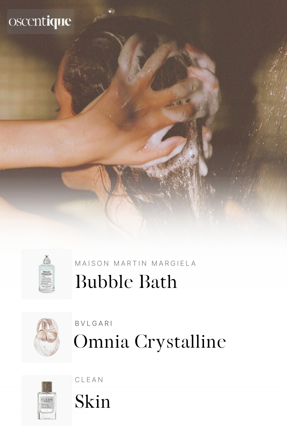 Close-up of a woman washing her hair, covered in foam, with soft lighting. Below, three perfumes appear: Maison Martin Margiela Bubble Bath, Bvlgari Omnia Crystalline, and Clean Skin.